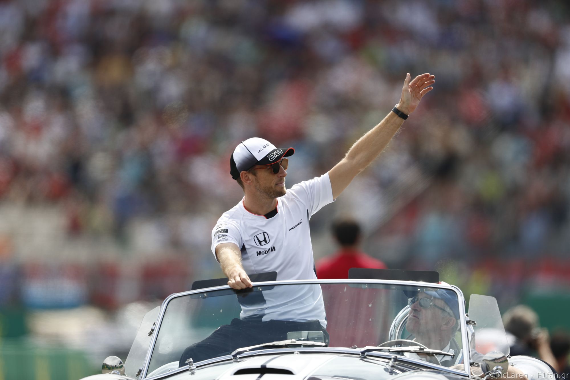 Jenson Button, McLaren, waves to fans on the drivers’ parade.